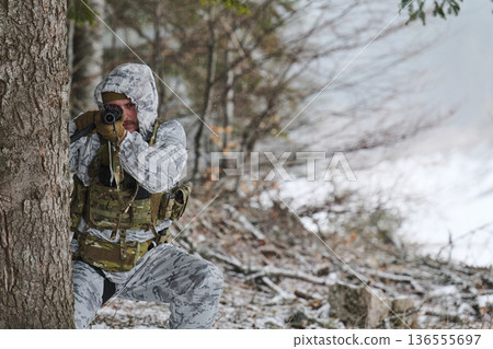 Winter Camouflage Soldier Aiming Rifle in Snowy Forest During Tactical Military Training And Reconnaissance Winter Camouflage Soldier Aiming Rifle in Snowy Forest During Tactical Military Training And Reconnaissance 136555697