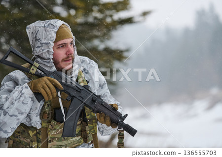 Soldier In Winter Camouflage Holding Assault Rifle During Cold Weather Patrol In Snowy Forest Training 136555703