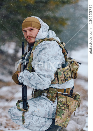 Soldier In Winter Snow Camo Gear Holding Rifle On Cold Weather Tactical Patrol 136555783
