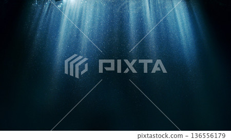 Dark Blue Ocean Surface Seen from Underwater. Abstract Waves and Rays of Sunlight Shining Through Dark Blue Ocean Surface Seen from Underwater. Abstract Waves and Rays of Sunlight Shining Through 136556179