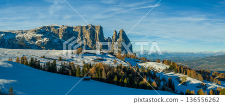 Panorama of the Dolomites mountains during autumn sunrise. Beautiful panorama of Alpe di Siusi , Italy Panorama of the Dolomites mountains during autumn sunrise. Beautiful panorama of Alpe di Siusi , Italy 136556262