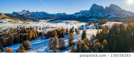 Panorama of the Dolomites mountains during autumn sunrise. Beautiful panorama of Alpe di Siusi , Italy Panorama of the Dolomites mountains during autumn sunrise. Beautiful panorama of Alpe di Siusi , Italy 136556263