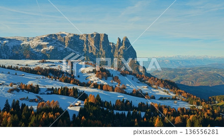 Panorama of the Dolomites mountains during autumn sunrise. Beautiful panorama of Alpe di Siusi , Italy Panorama of the Dolomites mountains during autumn sunrise. Beautiful panorama of Alpe di Siusi , Italy 136556281