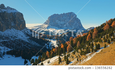 Panorama of the Dolomites mountains during autumn sunrise. Beautiful mountians of Alpi Dolomiti in Italy, South Tirol Panorama of the Dolomites mountains during autumn sunrise. Beautiful mountians of Alpi Dolomiti in Italy, South Tirol 136556282