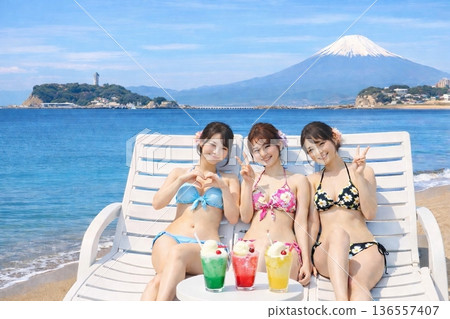 View of Enoshima and Mt. Fuji from a beachside cafe 136557407