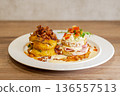 Gourmet breakfast plates with eggs benedict and savory pumpkin stack 136557513