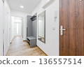 Modern apartment hallway interior with furniture and white walls 136557514