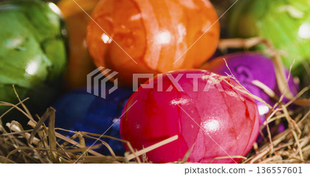 Colorful eggs in a nest during spring celebrations in a warm indoor setting Colorful eggs in a nest during spring celebrations in a warm indoor setting 136557601