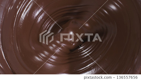 Mixing chocolate in a bowl at a kitchen counter during a baking session in the afternoon Mixing chocolate in a bowl at a kitchen counter during a baking session in the afternoon 136557656