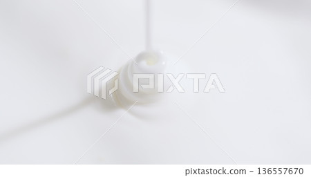 Action of pouring liquid from a plastic bottle onto a white surface for various uses and purposes in a kitchen or laboratory 136557670