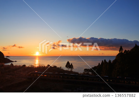 View of the Pacific Ocean sunrise and the Kisei Main Line express diesel railcar from the Kumano Kodo trail View of the Pacific Ocean sunrise and the Kisei Main Line express diesel railcar from the Kumano Kodo trail 136557882