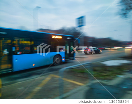 Motion Blur of Blue Bus Number 32 Speeding Through Budapest Streets at Dusk with Car Headlights and Urban Background in Hungary City Traffic Movement Long Exposure Style Artistic Evening Capture 136558864