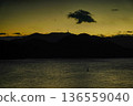 Twilight sea, mountain silhouette, golden sky, calm water surface, lonely cloud Twilight sea, mountain silhouette, golden sky, calm water surface, lonely cloud 136559040