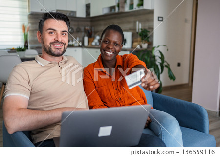 Couple Shopping Online Using Laptop and Credit Card at Home Couple Shopping Online Using Laptop and Credit Card at Home 136559116