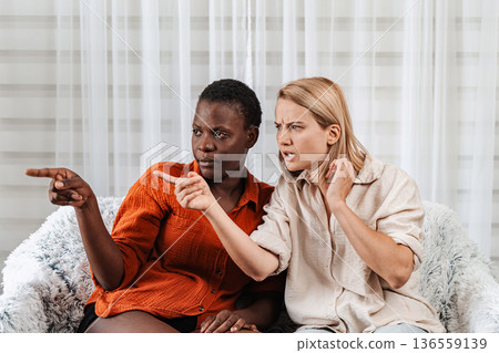 Two young women pointing and reacting to something off-screen Two young women pointing and reacting to something off-screen 136559139