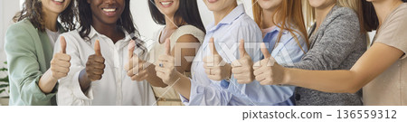 Smiling group of women showing thumbs up, celebrating unity and success together Smiling group of women showing thumbs up, celebrating unity and success together 136559312
