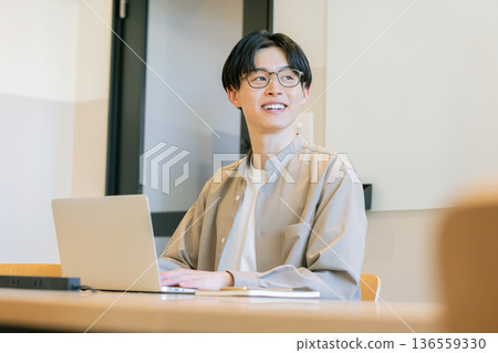 Man operating laptop at cafe Man operating laptop at cafe 136559330