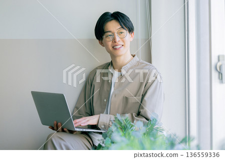 A man working on a computer at home A man working on a computer at home 136559336