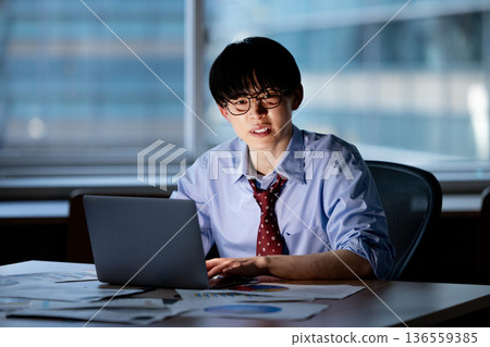 Businessman feeling tired after working overtime Businessman feeling tired after working overtime 136559385