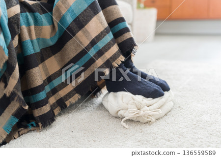 一位腳冷的女士正在使用熱水袋 一位腳冷的女士正在使用熱水袋 136559589