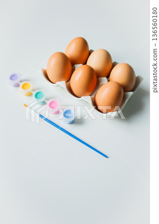 Easter eggs on a stand with paints and brush on white background. Eggs decoration before Easter holidays. Easter eggs on a stand with paints and brush on white background. Eggs decoration before Easter holidays. 136560180