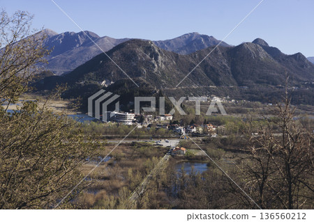 Skadar Lake National park panoramic landscape, Montenegro, Hiking in Skadar Lake, Skadarsko jezero, also called Shkodra or Scutari, with mountains and village in a sunny day, Montenegrin Balkan nature 136560212