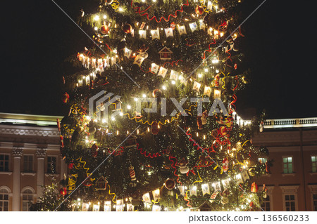 Christmas tree on Palace square, Saint-Petersburg, New Year and Christmas in Russia, glowing decor decoration in a winter snowy street, with night decor illumination, city outdoor lights and garlands Christmas tree on Palace square, Saint-Petersburg, New Year and Christmas in Russia, glowing decor decoration in a winter snowy street, with night decor illumination, city outdoor lights and garlands 136560233