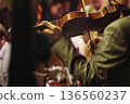 Concert view of violinist with vocalist and musical band, fiddler performing classical music, symphony orchestra performing music, violin player on stage in a club, music arena hall, fiddle and bow 136560237