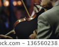 Concert view of violinist with vocalist and musical band, fiddler performing classical music, symphony orchestra performing music, violin player on stage in a club, music arena hall, fiddle and bow 136560238