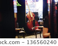 Concert view of contrabass violoncello player with vocalist and musical band during string concert, jazz orchestra performing music, violoncellist cello jazz player on stage in club, music arena hall 136560240