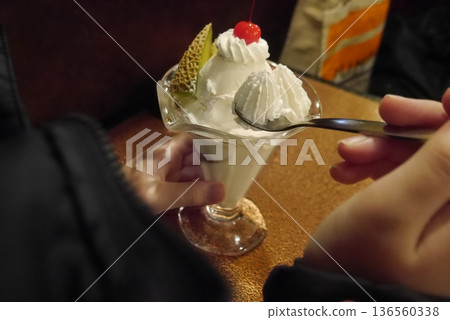 Eating a fruit parfait Eating a fruit parfait 136560338