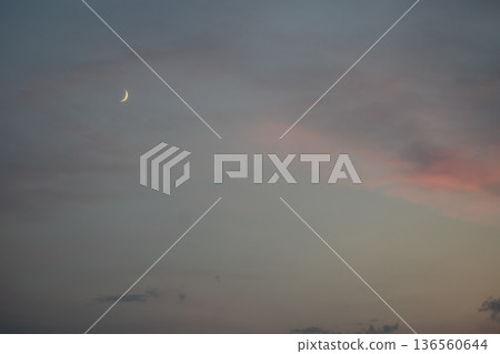 Crescent moon in the sunset sky Crescent moon in the sunset sky 136560644
