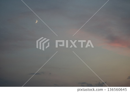 Crescent moon in the sunset sky Crescent moon in the sunset sky 136560645
