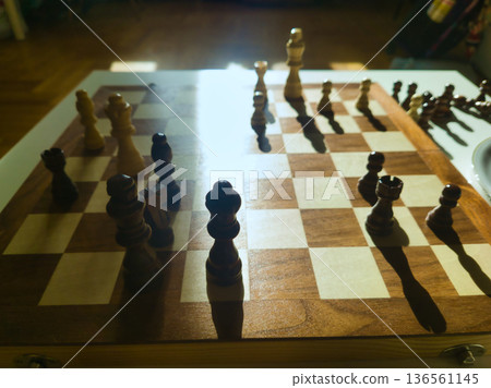 Budapest Interior Lifestyle Wooden Chessboard Strategy Game with Natural Sun Flare Close Up Detail of Pieces and Board Patterns During Family Home Match Hungary Urban Living Budapest Interior Lifestyle Wooden Chessboard Strategy Game with Natural Sun Flare Close Up Detail of Pieces and Board Patterns During Family Home Match Hungary Urban Living 136561145