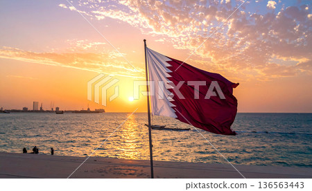 Qatar Flag Waving at Sunset by the Sea Qatar Flag Waving at Sunset by the Sea 136563443