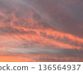 夕陽將天空和雲彩染成了深紅色。 136564937