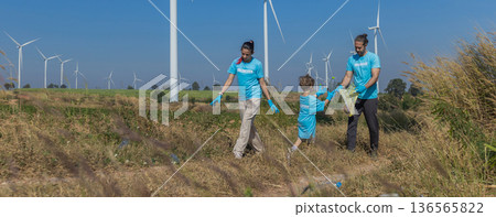 Family collecting garbage at park 136565822