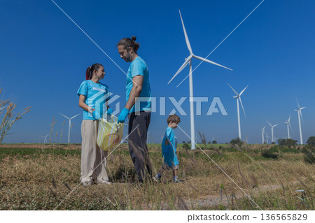 Family collecting garbage at park 136565829