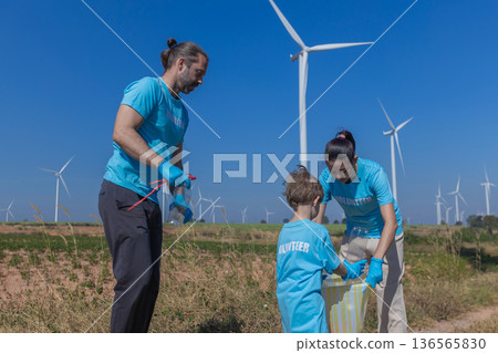 Family collecting garbage at park 136565830