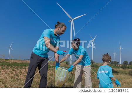 Family collecting garbage at park 136565831