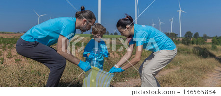Family collecting garbage at park 136565834