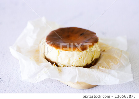 Cheesecake with baking paper on white marble table. Cheesecake with baking paper on white marble table. 136565875