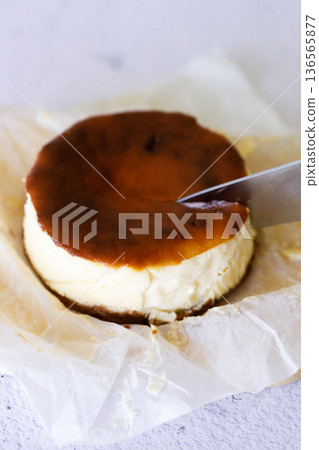 Cheesecake with baking paper on white marble table. Cheesecake with baking paper on white marble table. 136565877