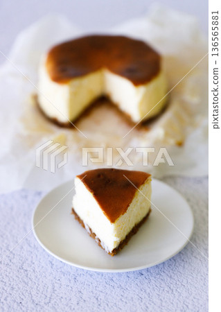Cheesecake with baking paper on white marble table. Cheesecake with baking paper on white marble table. 136565881