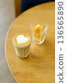 Cup of coffee latte art on wood table. 136565890