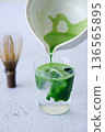 Iced matcha drink with water in a glass. 136565895