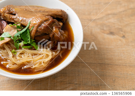 Braised duck noodles with brown soup 136565906
