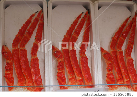 High-quality frozen king crab legs neatly arranged in white trays, showcasing their bright red shells and premium seafood texture. Commonly seen in seafood markets, gourmet stores, luxury food premium High-quality frozen king crab legs neatly arranged in white trays, showcasing their bright red shells and premium seafood texture. Commonly seen in seafood markets, gourmet stores, luxury food premium 136565993