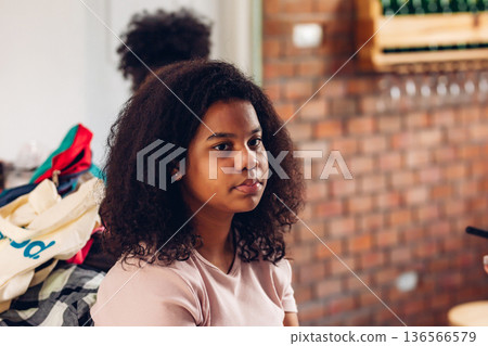 Stylist is putting make up on black woman eyebrows with the eyebrows brush. 136566579