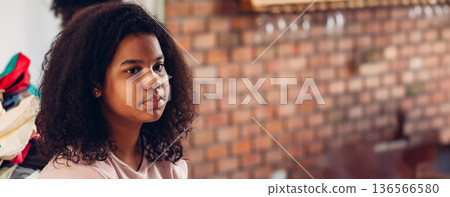 Stylist is putting make up on black woman eyebrows with the eyebrows brush. 136566580